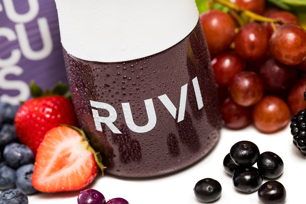 Ruvi focus smoothie in a shaker bottle surrounded by berries and tart cherry