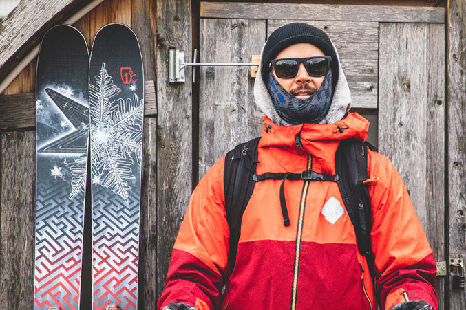 Julian Carr skiing legend standing outside with snow coat and skis