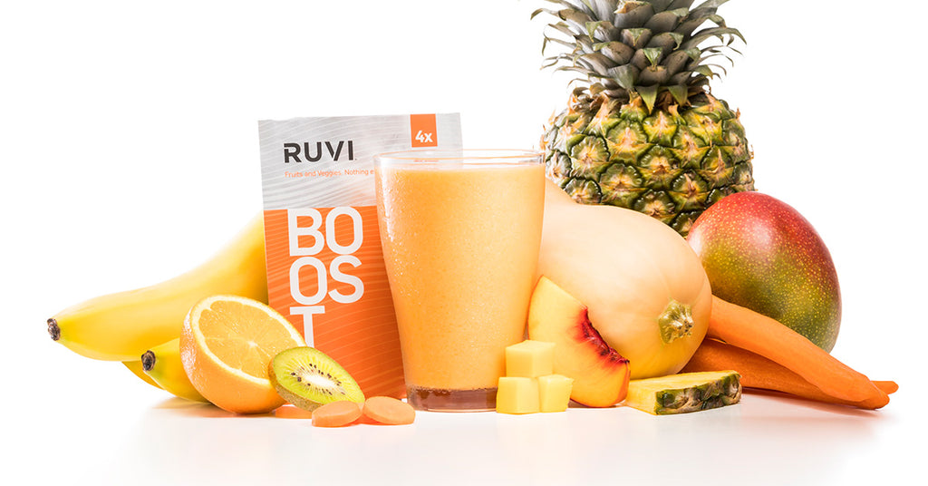 Ruvi Boost Smoothie surrounded by tropical fruits, pineapple, carrot, butternut squash