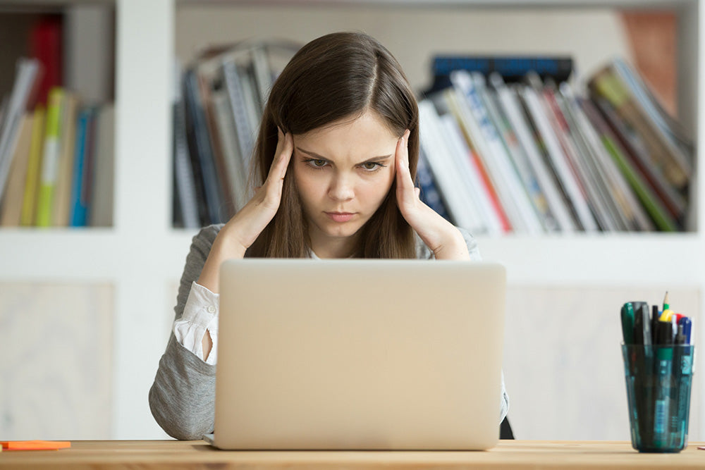 Woman staring at computer screen having a hard time concentrating