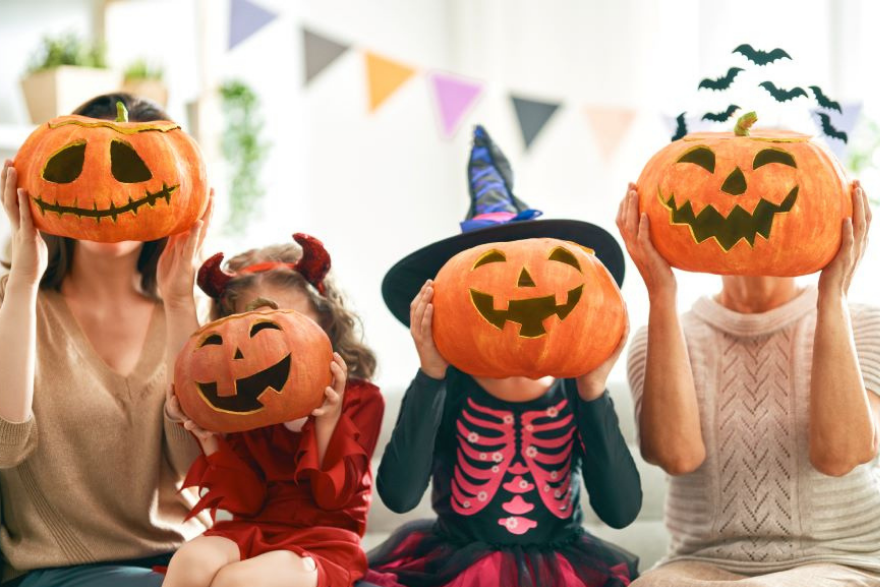 Children with pumpkins on their heads for Halloween