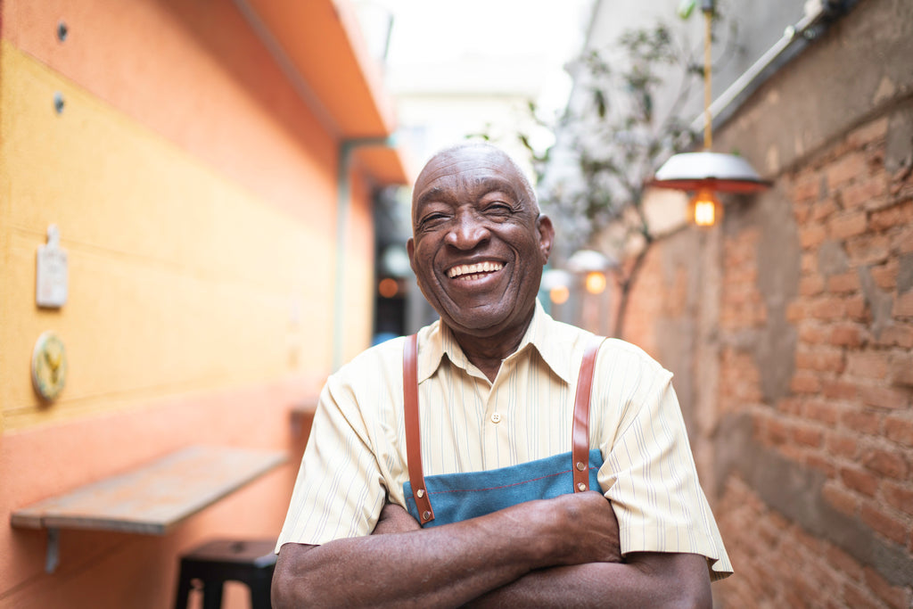 Middle aged man smiling and folding his arms