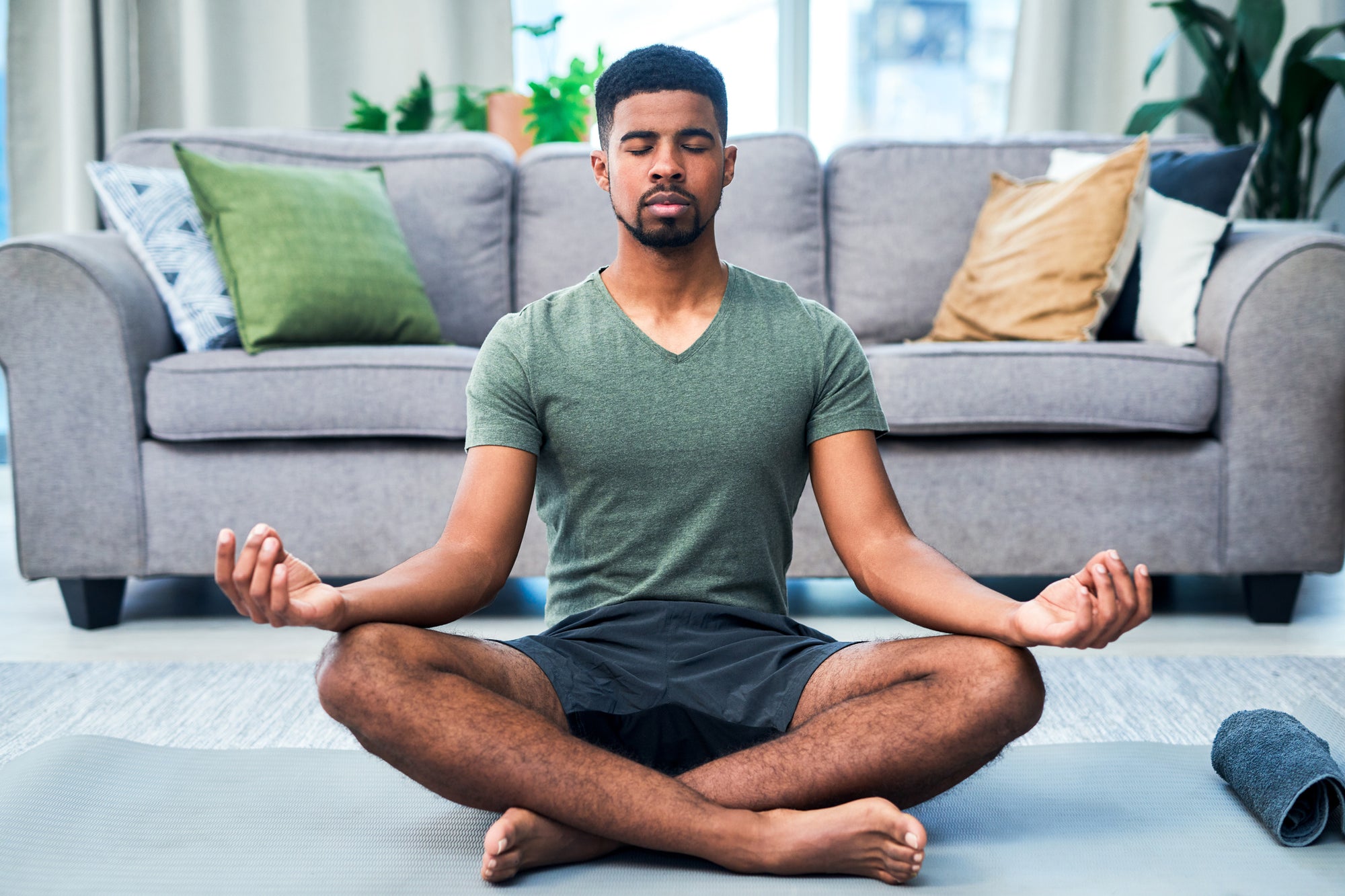 Man sitting cross-legged meditating